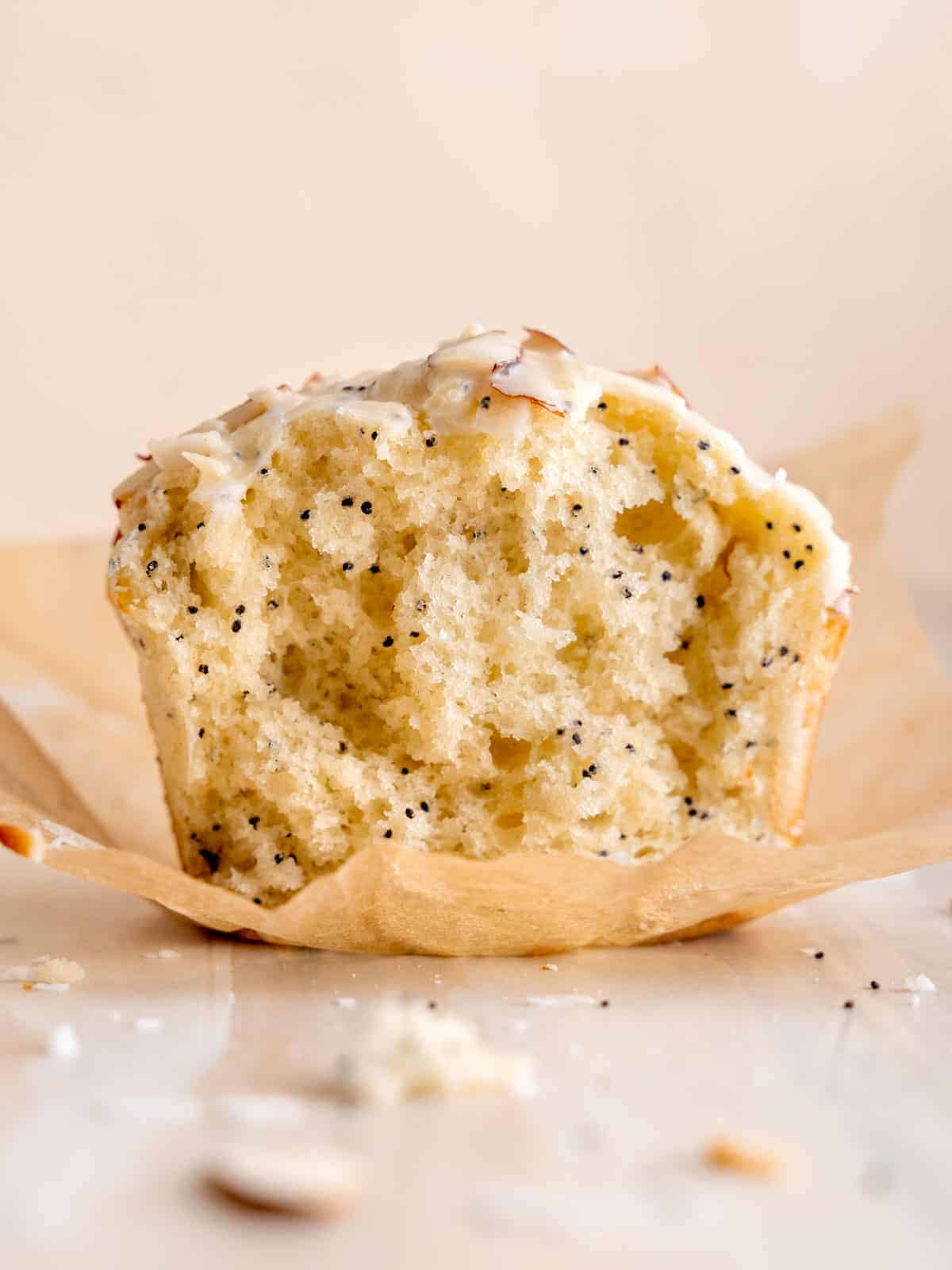 A side shot of a poppy seed muffin cut in half.