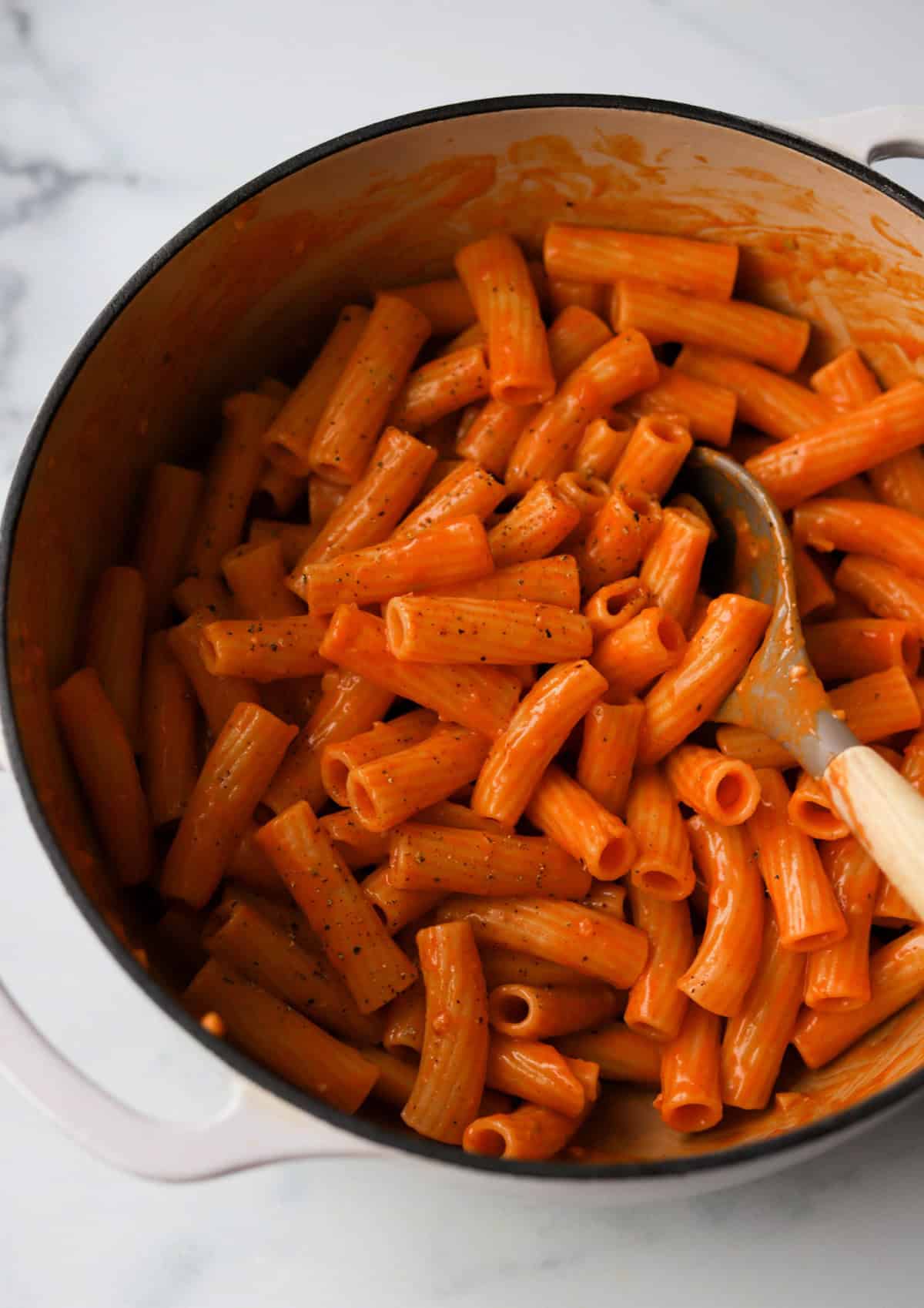 A close up front shot of a pot of creamy gochujang pasta.